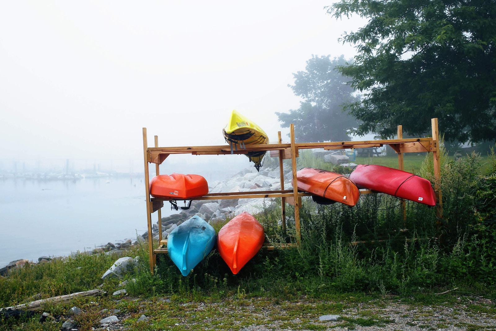 a group of red and blue objects on a wooden platform by a body of water
