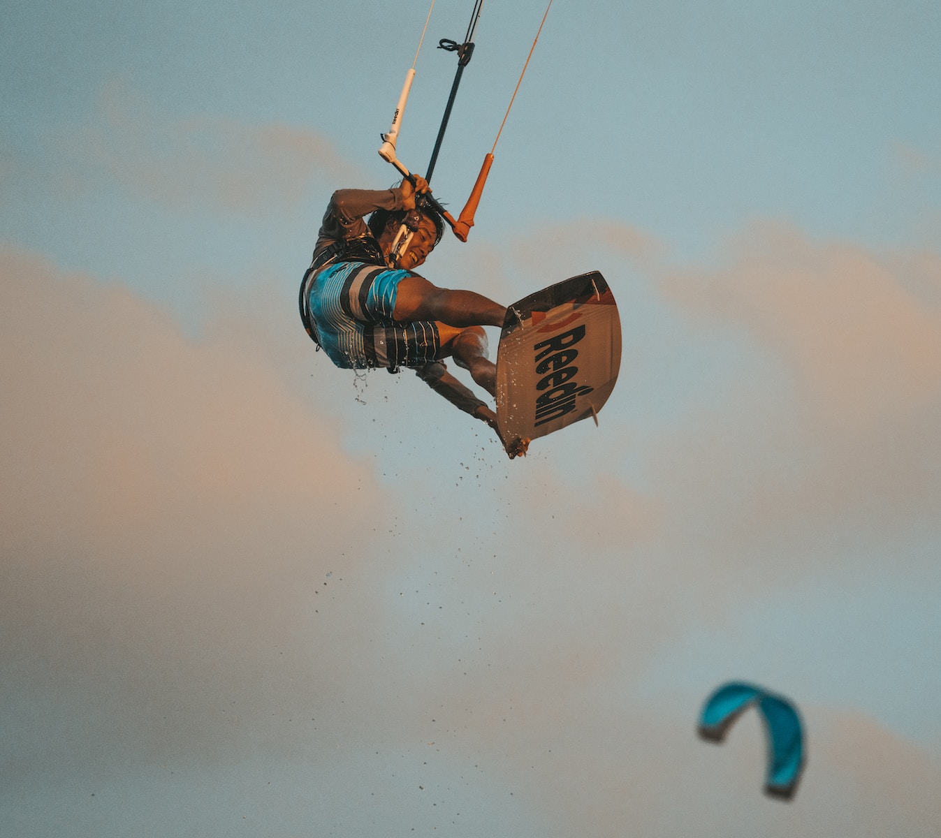 a man flying through the air while riding a kiteboard
