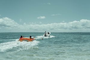 orange and white inflatable boat on sea during daytime