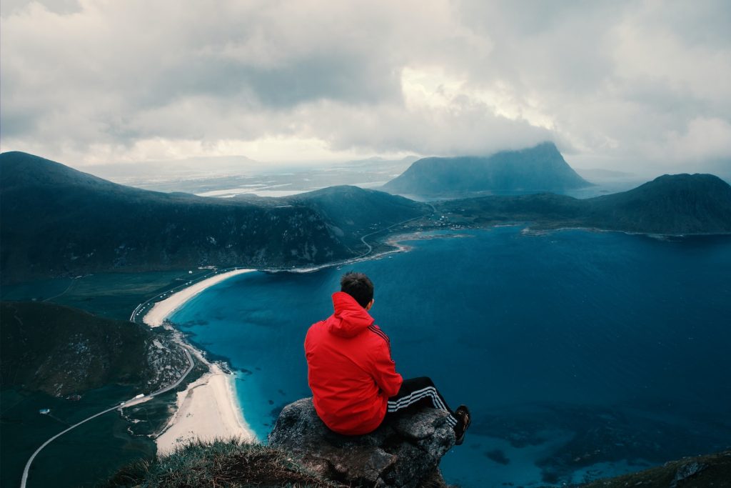 person sitting across body of water