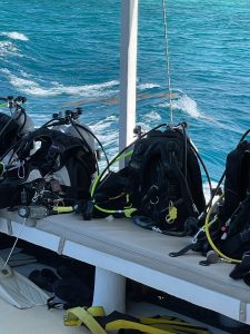 scuba gear are lined up on a boat